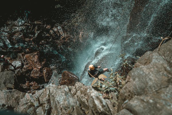 Man Rappelling on Cliff in Guyana