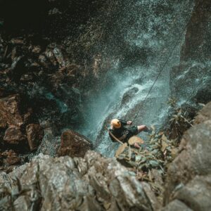 Man Rappelling on Cliff in Guyana